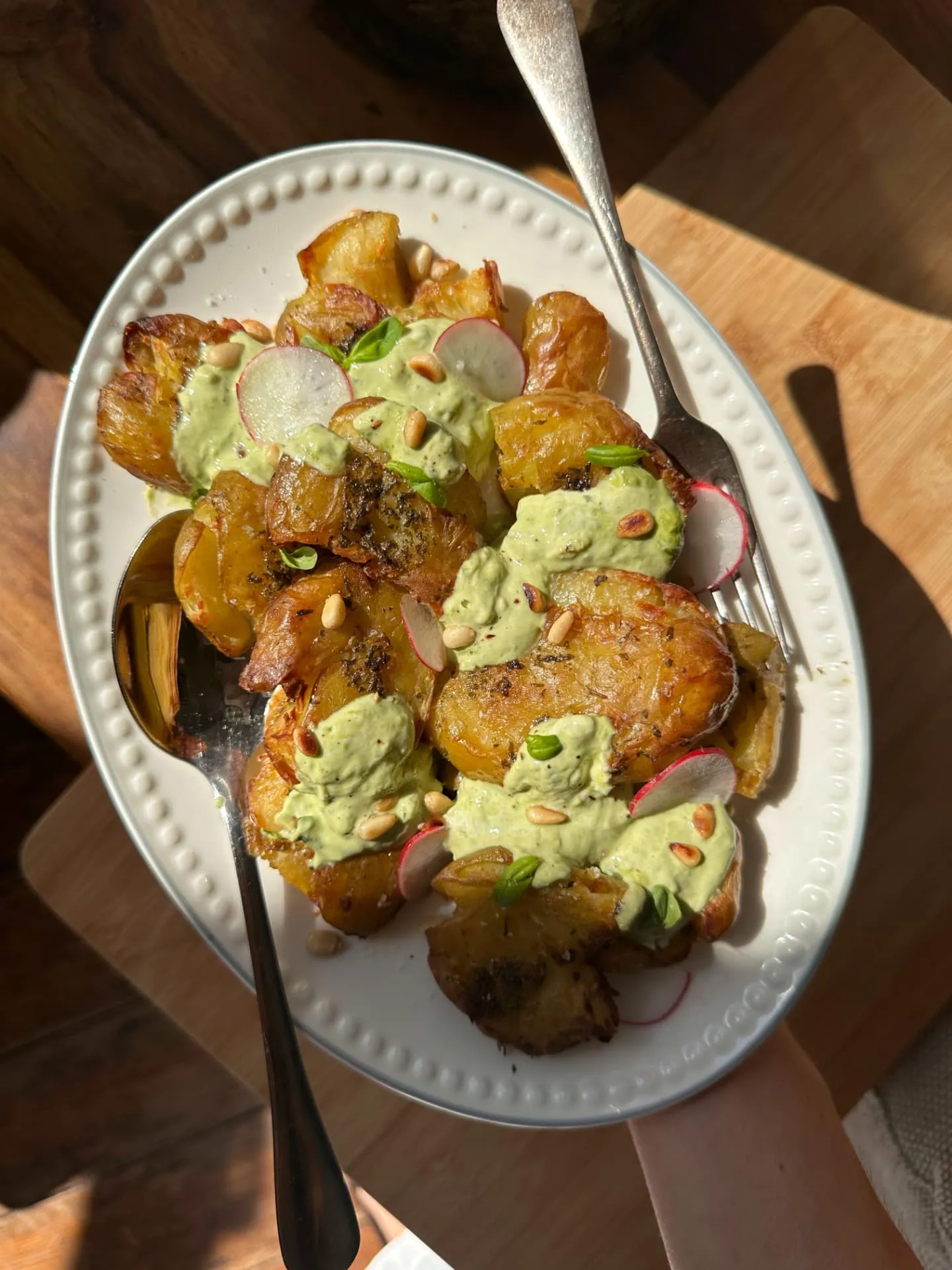 Crispy smashed potatoes with herby green sauce and radish
